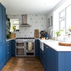 blue kitchen with white hexagonal tiles