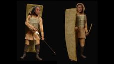 a reconstruction of a Russian warrior in battle gear with a bow and arrow