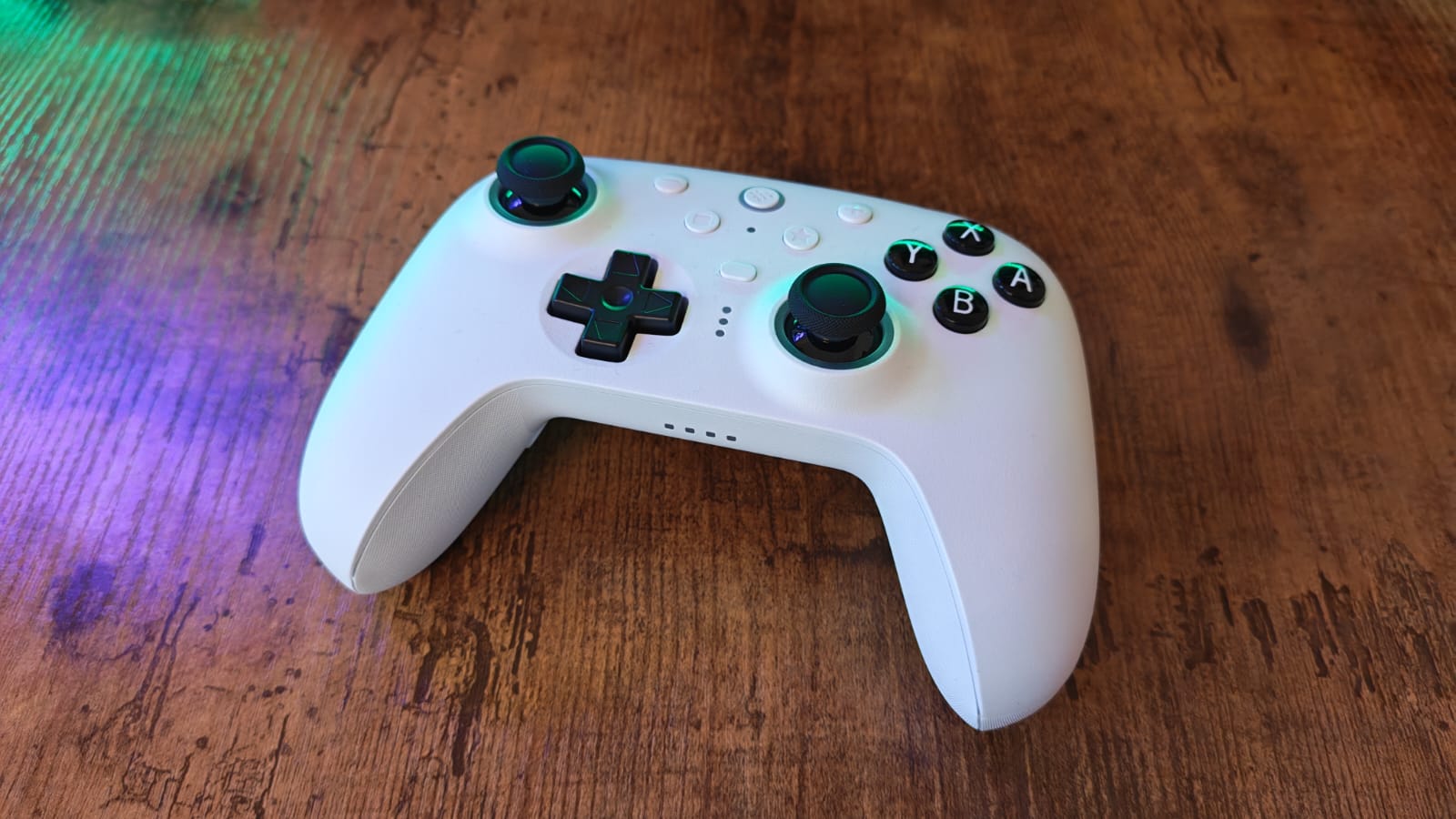 The 8BitDo Ultimate 2 laid out on a wooden desk surface