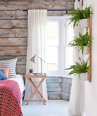 Bedroom with paneled walls and plants