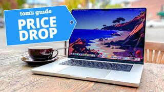 MacBook Pro 16-inch 2021 sitting on a patio table with deal tag