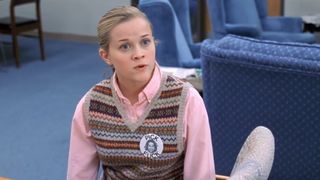 Reese Witherspoon wears a sweater vest and button as Tracy Flick in Election