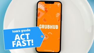 Grubhub app on iPhone with phone on plate