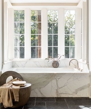 White bathroom with bath with Calacatta marble surround