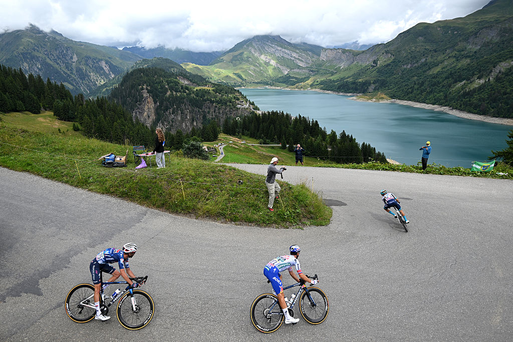 LA PLAGNE, FRANCE - JULY 25: (L-R) Valentin Paret-Peintre of France and Team Soudal Quick-Step, Primoz Roglic of Slovenia and Team Red Bull - BORA - hansgrohe and Lenny Martinez of France and Team Bahrain - Victorious compete in the breakaway climbing down the Col du Pre (1729m) during the 112th Tour de France 2025, Stage 19 a 93.1km stage from Albertville to La Plagne 2062m / #UCIWT / Stage route modified over infected cattle / on July 25, 2025 in La Plagne, France. (Photo by Dario Belingheri/Getty Images)