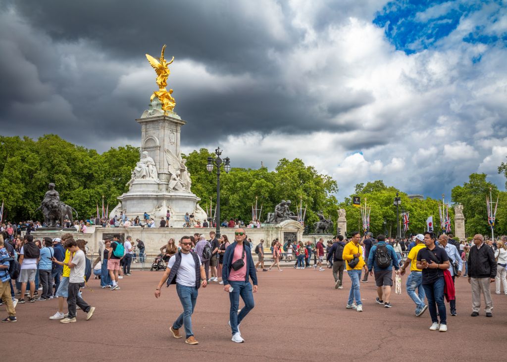 Tourists next to the Victoria Memorial at the end of The Mall outside Buckingham Palace