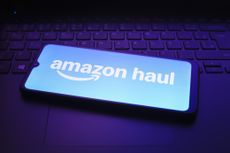Amazon Haul logo on a smartphone resting on a laptop