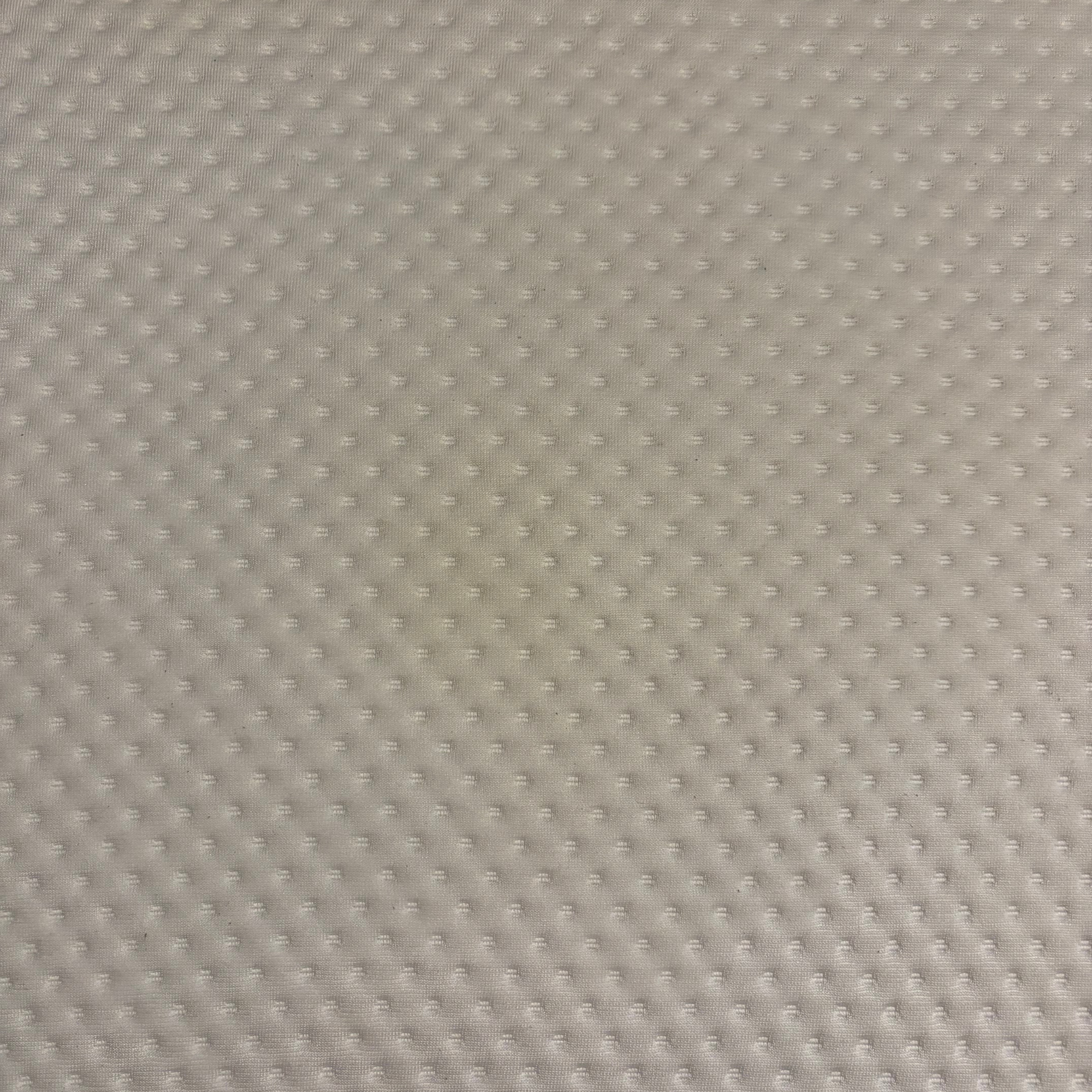 Quilted white / cream mattress fabric up-close after spot cleaner use