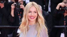 Sienna Miller attends the "Horizon: An American Saga" Red Carpet during the 77th Annual Cannes Film Festival at Palais des Festivals on May 19, 2024 in Cannes, France.