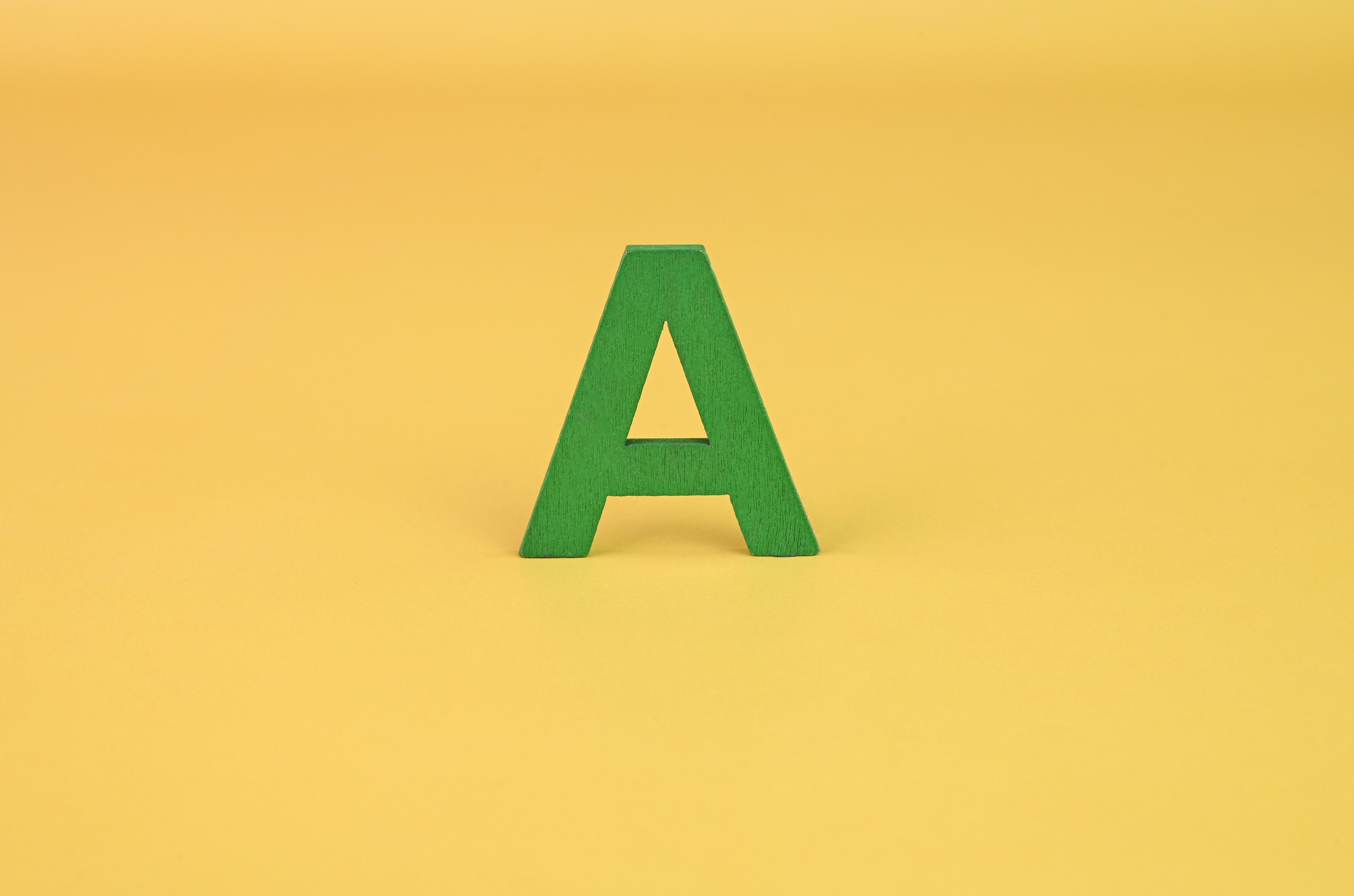 Isolated letter A on a yellow background.