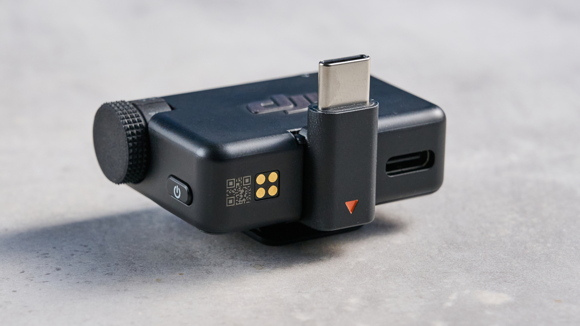the dji mic mini 2 for camera and smartphone conent creators photographed against the blue tom's guide background