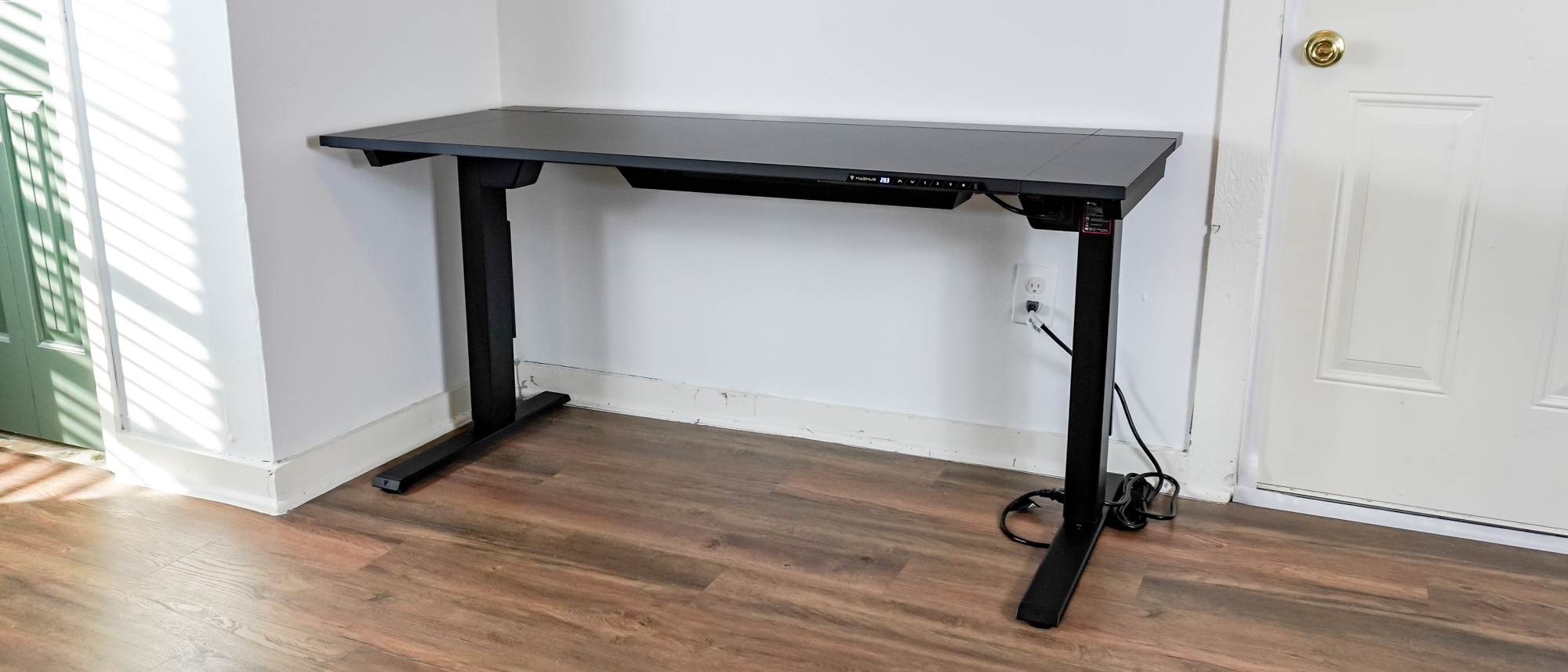 The Secretlab Magnus Evo standing desk up against a wall