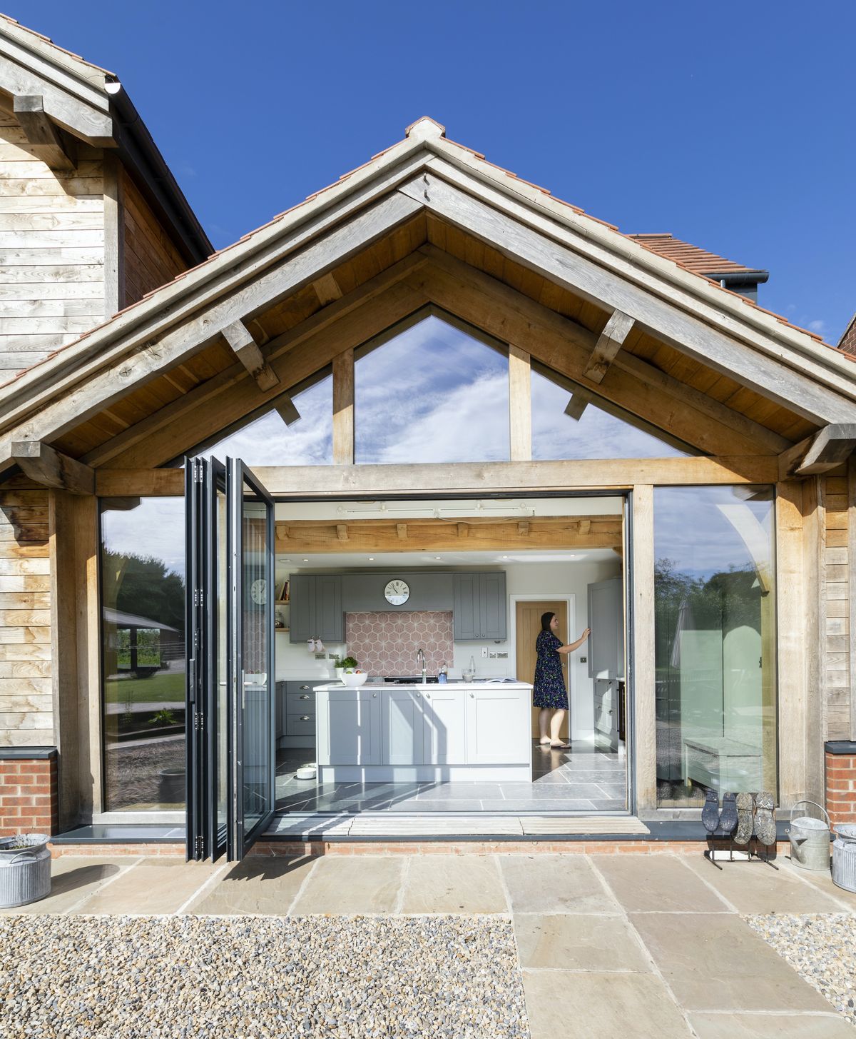 The French chestnut cladding will weather while the bifold doors connect the house to the beautiful countryside.