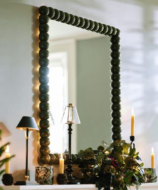 fall mantel with foliage and tealights and a portable lamp