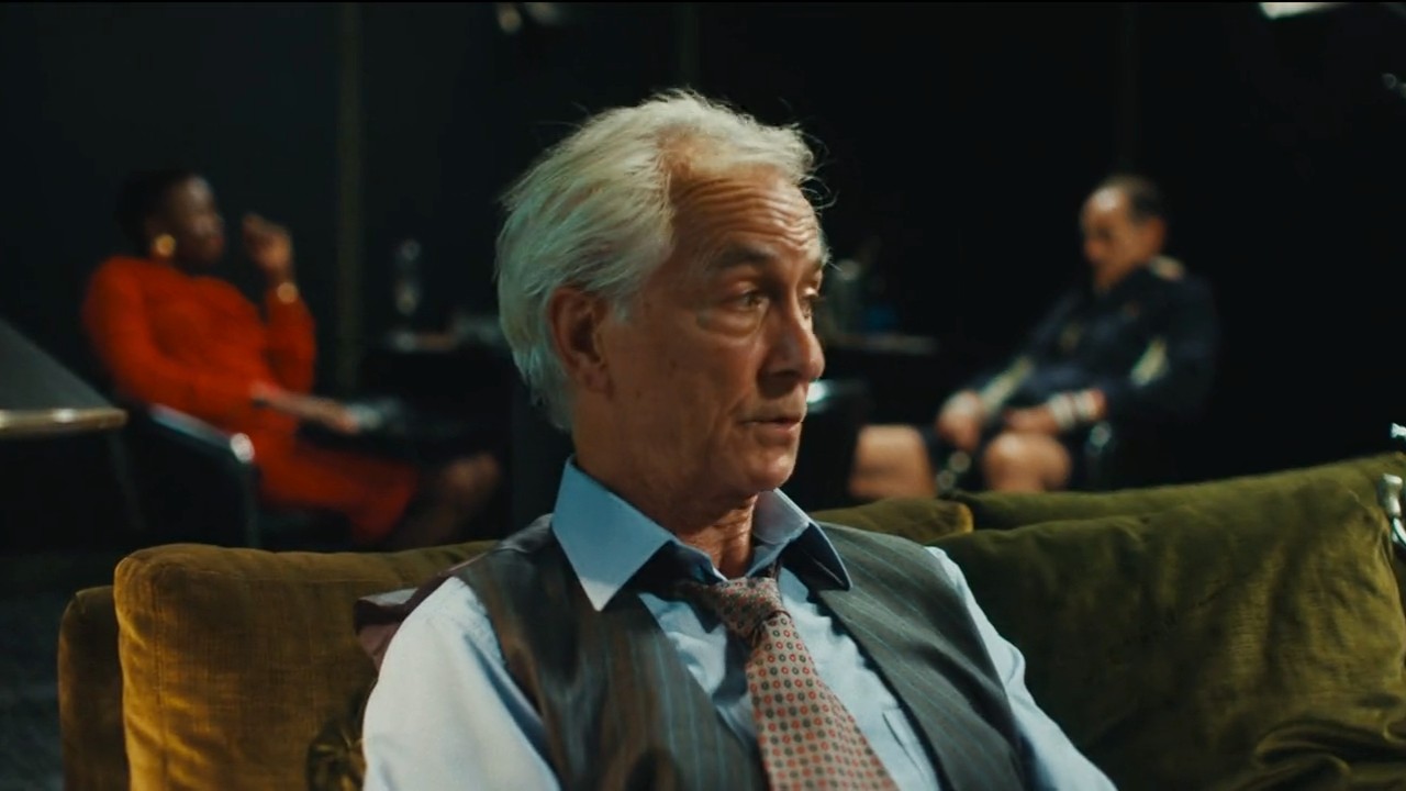 David Strathaim is sitting and looking off in The Luckiest Man in America.