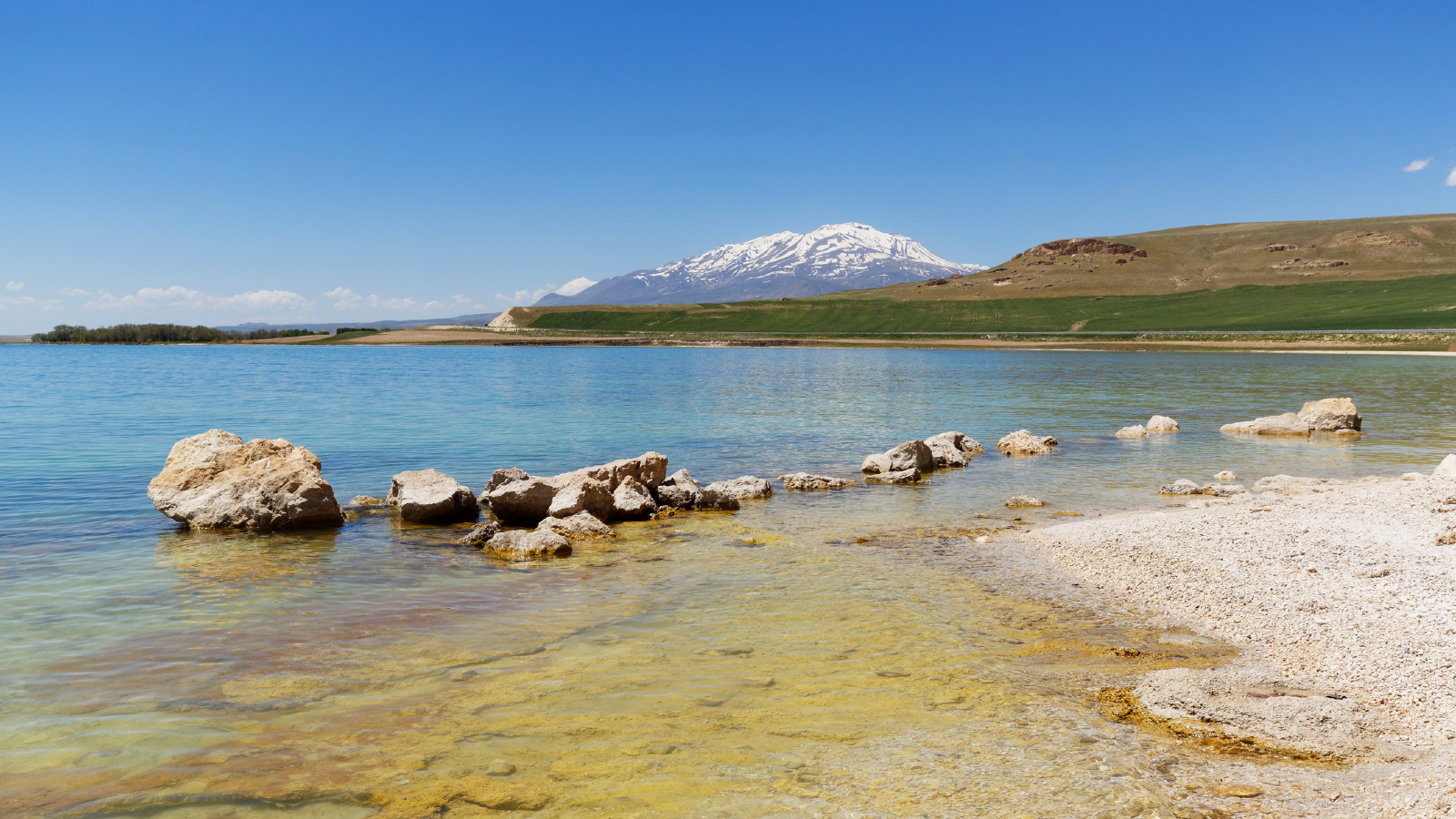 A photo taken from the shore of Lake Van, showing Mount Süphan in the background