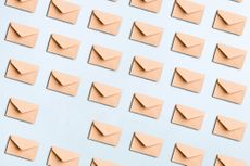 Directly above view of many beige envelopes on a blue colored background for mail