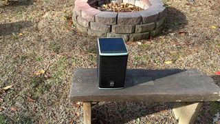 Lodge Solar Powered Speaker outdoors by a fire pit