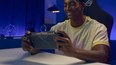Xbox ROG Ally X being played by man in blue/purple room