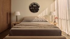 Image of a neutral, cozy bedroom with textured bedding and curtains over the window on the right wall.