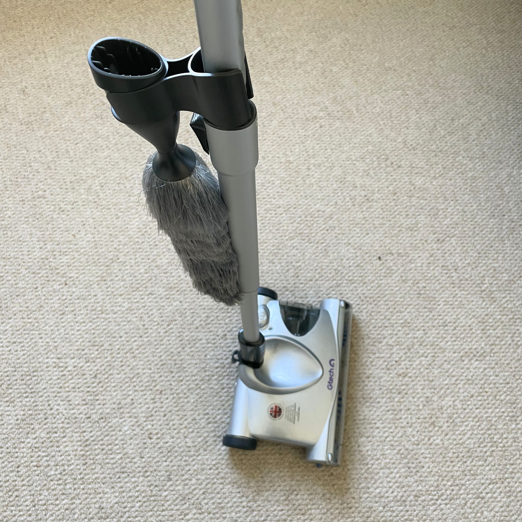 Gtech SW02 Cordless Lithium Carpet and Hardwood Floor Sweeper sitting on cream carpet