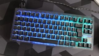The Wooting 8-HE on a mouse pad with RGB lighting enabled.