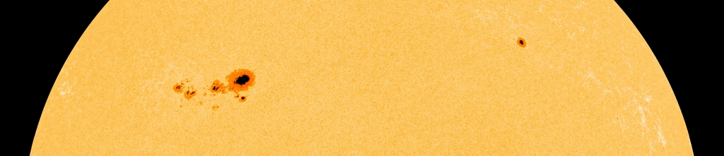 an animation showing a large dark spot move across the sun's surface from left to right