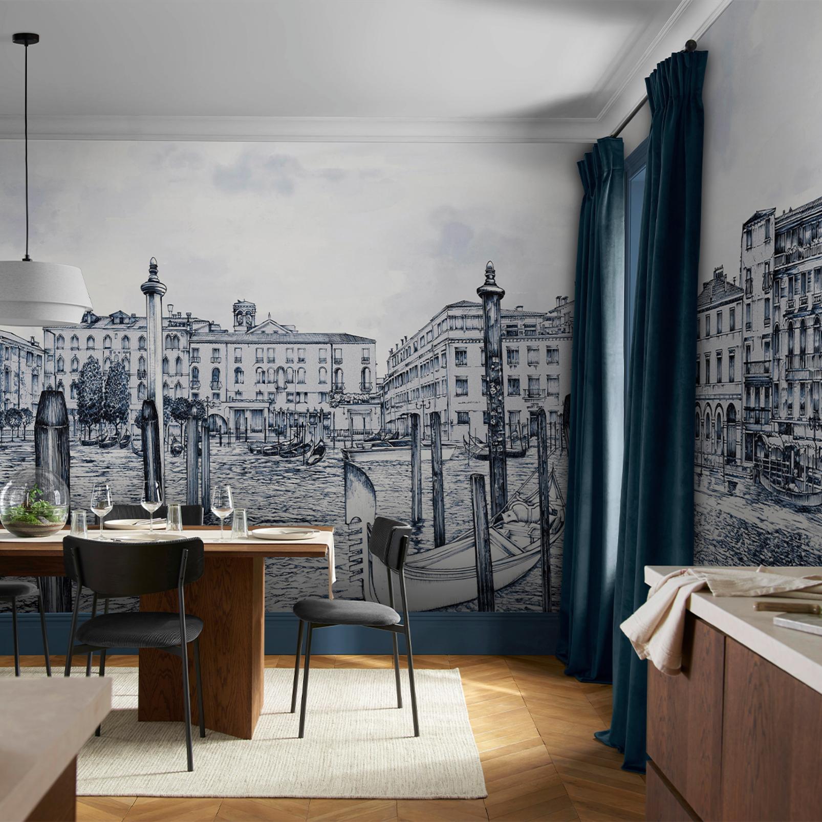 Image of a contemporary dining room with a wooden dining table and thin black chairs. The wall is covered in a blue and white panoramic wall mural.