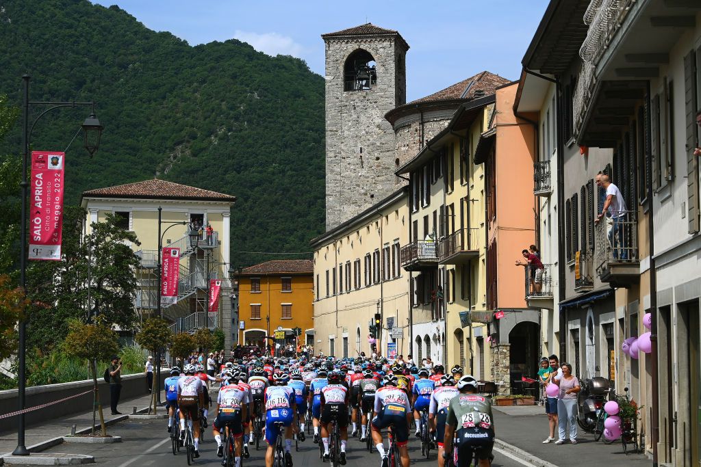 APRICA ITALY MAY 24 A general view of the Peloton passing through Vobarno Village during the 105th Giro dItalia 2022 Stage 16 a 202km stage from Sal to Aprica 1173m Giro WorldTour on May 24 2022 in Aprica Italy Photo by Tim de WaeleGetty Images