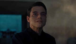 Rami Malek flashing an evil smile in No Time To Die.