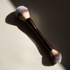 Image of a foundation brush on a clean, sunlit surface.