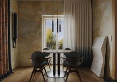 A dining room with textural alls and mid-century furniture