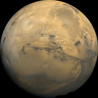 The vast Valles Marineris carves across the center of this view of the Martian globe, taken by a NASA spacecraft.