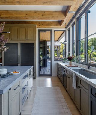 Industrial style kitchen with wooden beams and wooden cabinets with steel countertops