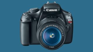 Canon EOS Rebel T3 with kit lens against a light blue background