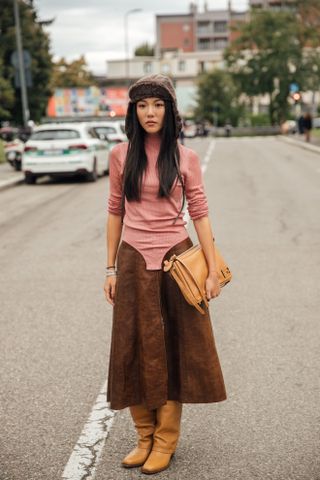 Fashion week boho street style outfit with light brown leather knee boots