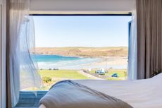 View from bedroom window onto a beach