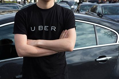 A man wears an Uber shirt.