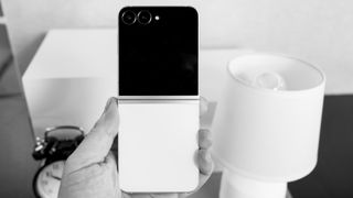 Samsung Galaxy Z Flip 7 FE in white with a black cover display