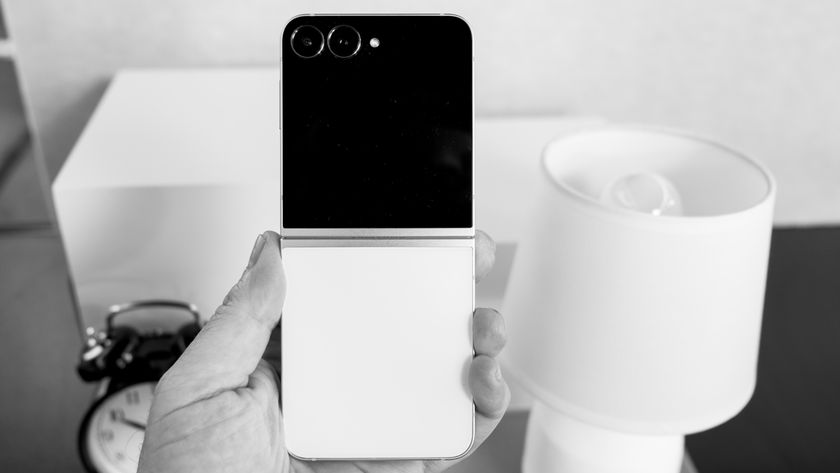 Samsung Galaxy Z Flip 7 FE in white with a black cover display