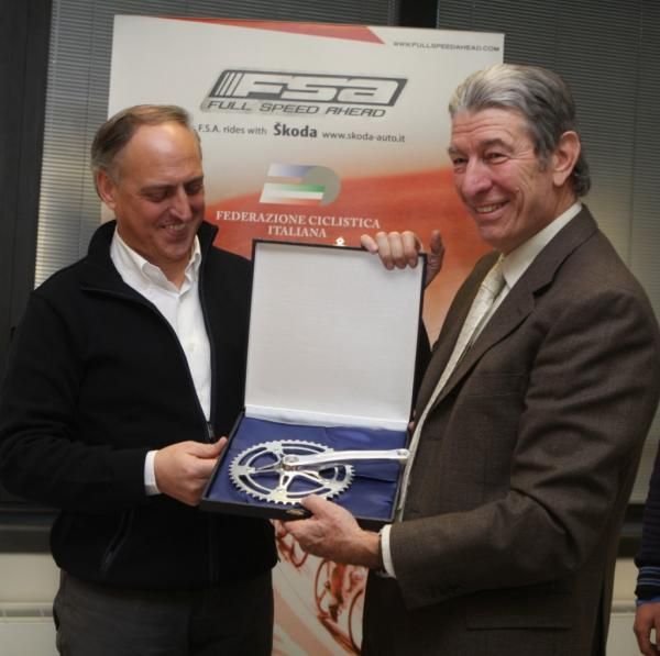 Felice Gimondi (right) assists FSA's Claudio Marra in presenting one of the company's products