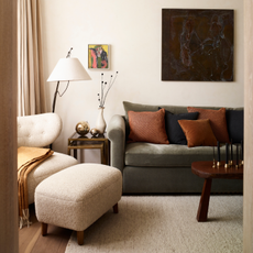 Drak green sofa and dark wood coffee table in neural living room.