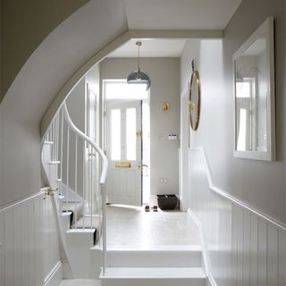 hallway with white wall and stairs