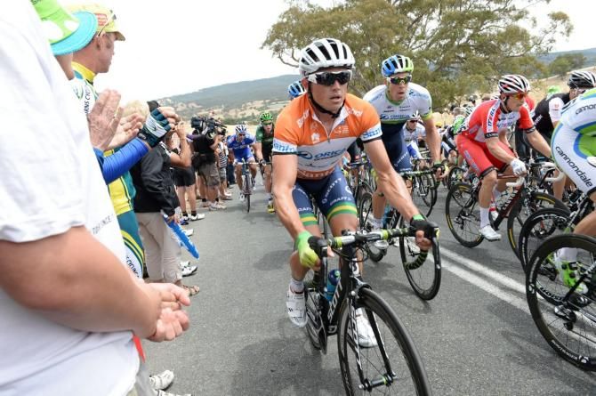 Race leader Simon Gerrans (Orica-GreenEdge) moves up the side of the peloton