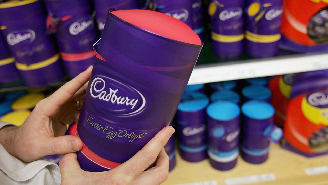 A man lifts a Cadbury Chocolate easter egg from the shelf at Cadbury World visitor centre on February 25, 2005 in Birmingham, England. The company is celebrating 100 years of manufacturing at the Bournville Cadbury factory. 