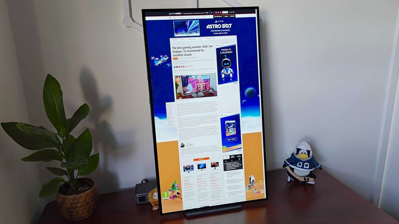 LG UltraGear 32GS95UE-B in portrait mode with GamesRadar+ Best Gaming Monitor guide on screen