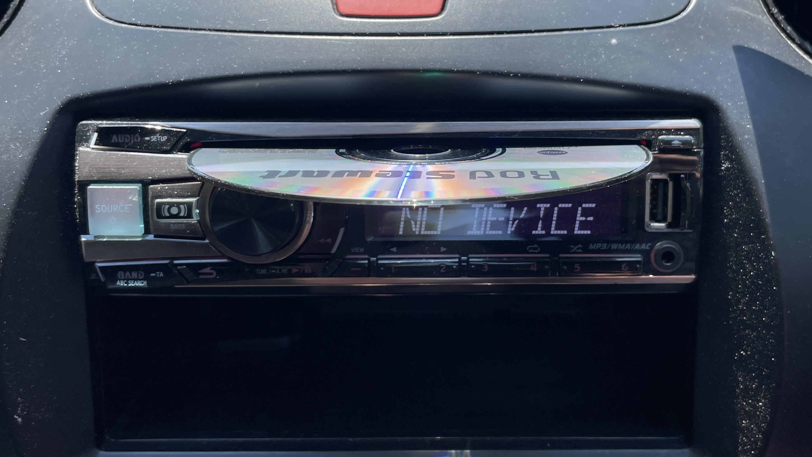 A car's CD player and burned CDs, on a hot day