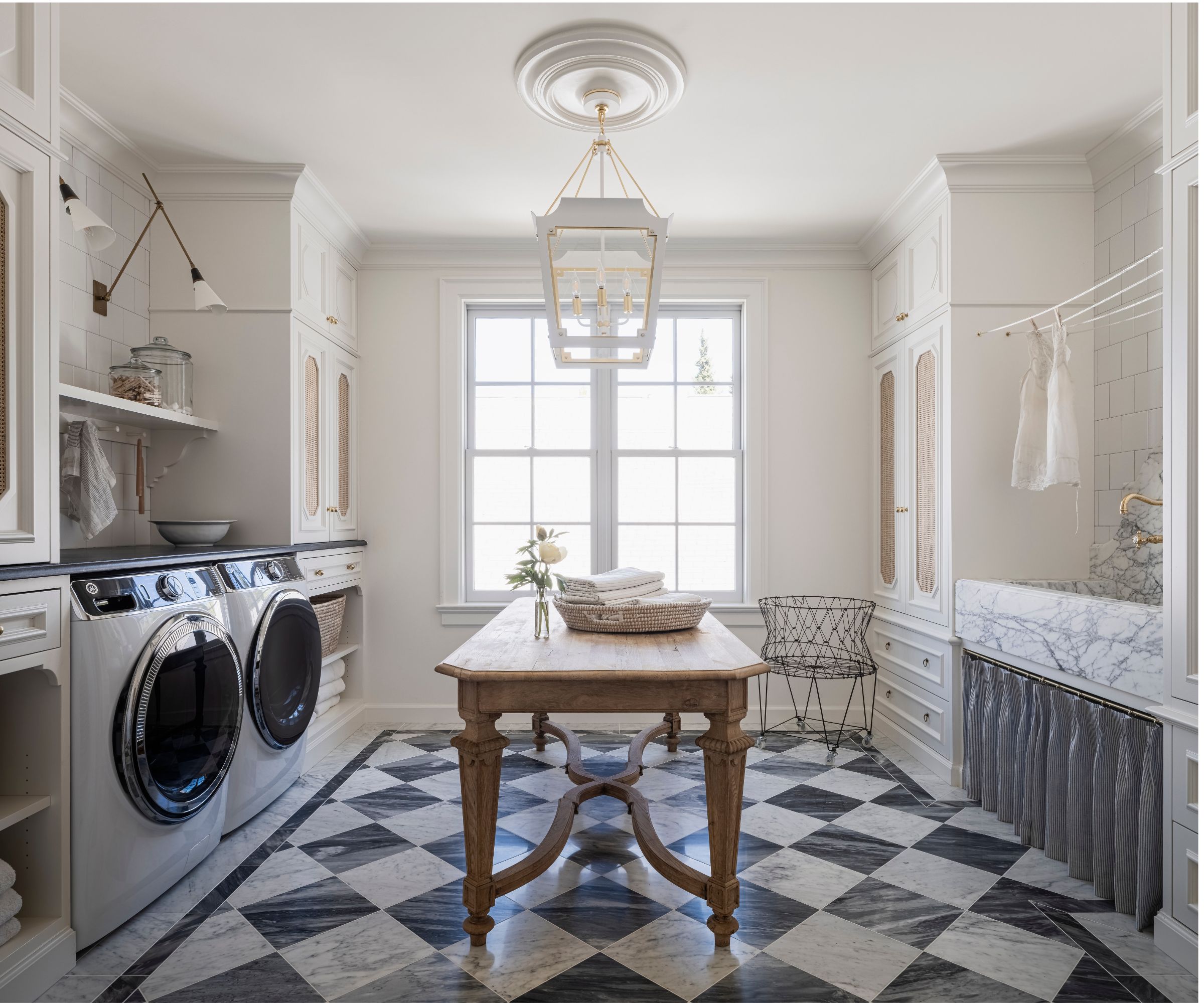 French inspired laundry room with fretwork cabinets and an antique central table, marble floor and marble sink. Project by Kat Lawton Interiors, photograph Kara Mercer