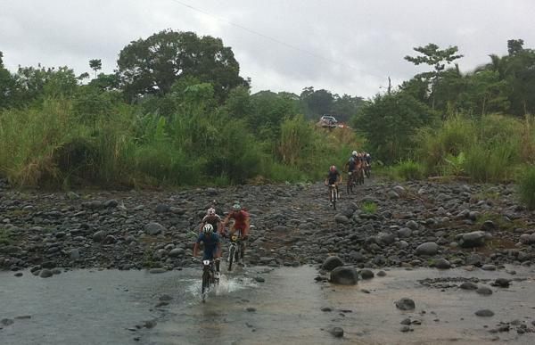 Racers cross a river early in stage 3