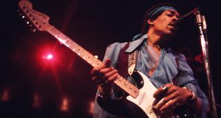 Jimi Hendrix plays a black Fender Stratocaster with a white pickguard